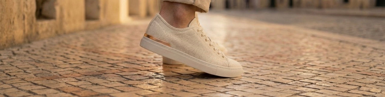 ERTH CLASX sandstone white sneakers on a cobblestone street