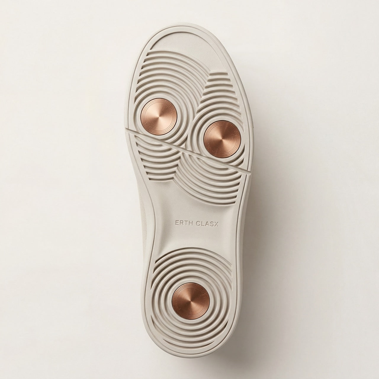 ERTH CLASX tri-ground copper node outsole close-up with rose gold accents on a off white background
